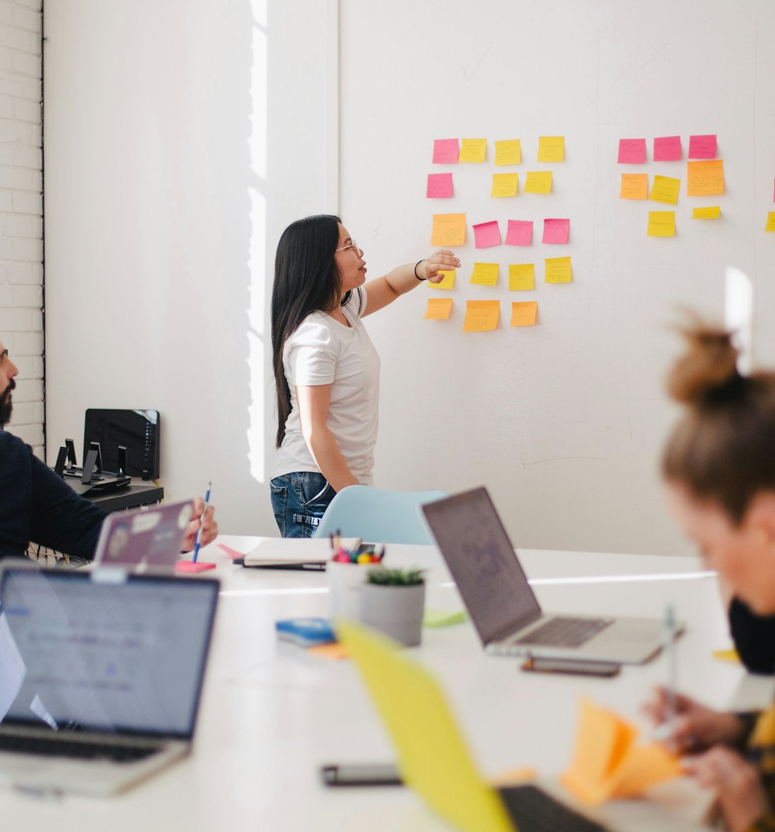 Team members mapping out a client project on a whiteboard